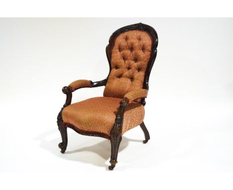 A Victorian mahogany show frame armchair with button back and carved cabriole legs