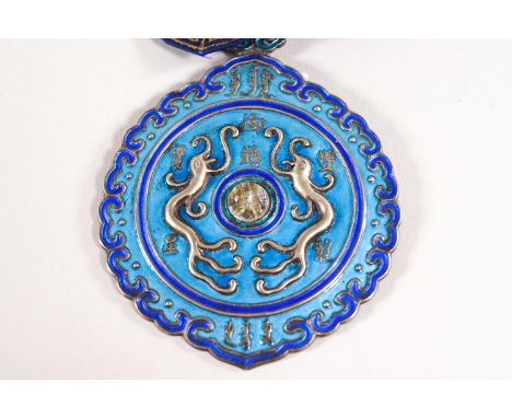A Chinese silver gilt and enamel Order of the 'Double Dragon', fourth class, third degree, with blue silk sash, embroidered w