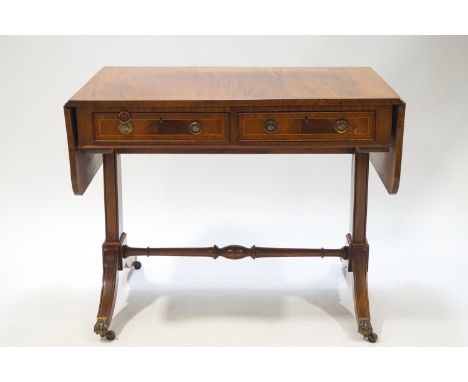 An early 20th century mahogany sofa table, the splayed legs with brass paw terminals and casters, 74.5cm high x 95cm wide x 6