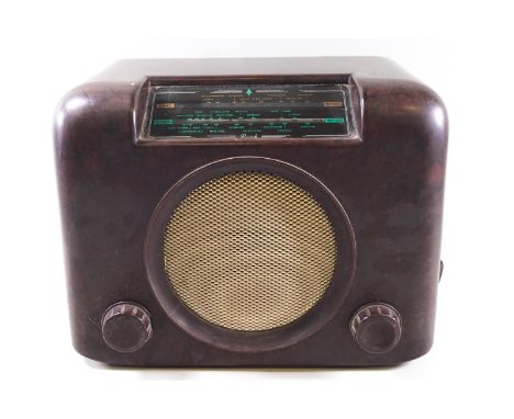 A Bakelite cased Bush radio, the front with central speaker and two control knobs, 22cm high x 30.5cm wide x 17cm deep