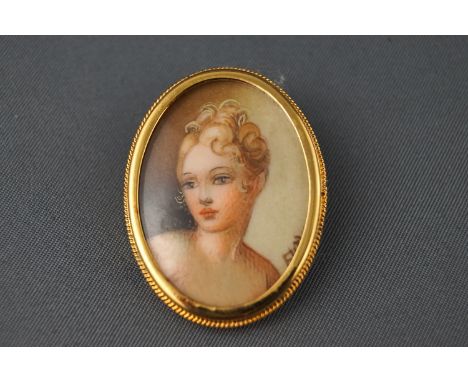 A miniature watercolour portrait brooch, in yellow metal frame, stamped 800 (silver gilt) 6.0 grams