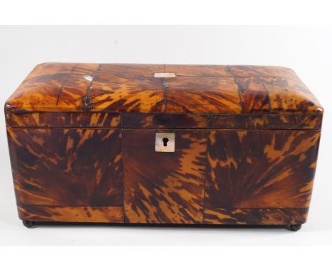 A George III tortoiseshell tea caddy inlaid with mother of pearl on ball feet, 13.5cm high x 29.5cm wide x 14cm deep