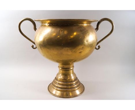 A large scale brass two handled urn with flared foot, 36.5cm high