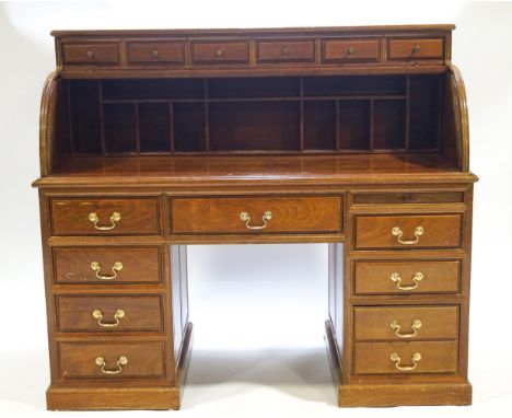 A contemporary mahogany bureau with six small drawers over a tambour top raised on two drawer set pedestals with brass handle