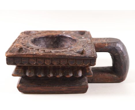 An Indian (possibly Rajasthan) square carved wood light holder with loop handle, 21cm long