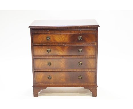 A mahogany veneered dressing chest of four drawers, with a brushing slide on raised bracket feet, bearing a "Jaycee" label, 8