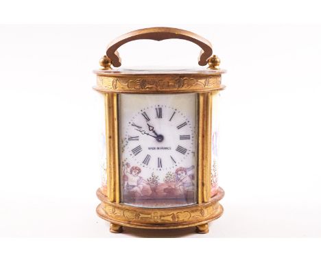 A 20th century carriage clock, of oval form, with enamel dial and side panels painted with Putti, 11cm high