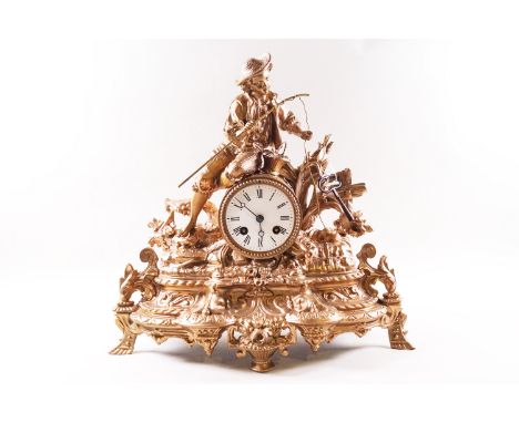 A late Victorian mantel clock, the spelter and gold painted case surmounted with a boy fishing, enclosing an enamel dial, the