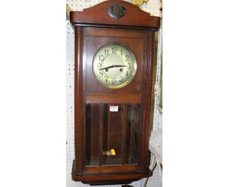 A 1930s walnut droptrunk wall clock (lacking weights and pendulum); together with a further Continental walnut droptrunk wall