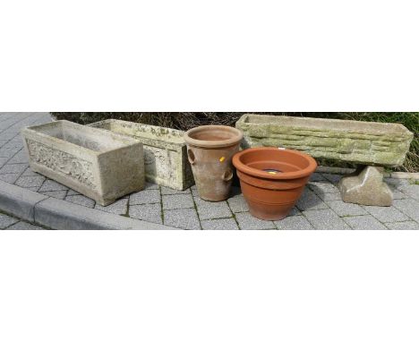 Three various reconstituted stone rectangular garden trough planters, together with two terracotta plant pots and a further s