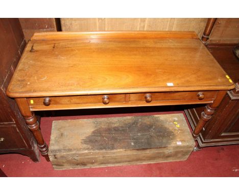 A Victorian mahogany round cornered ledgeback two drawer writing table, on turned tapering supports, w.120cmTop is discoloure