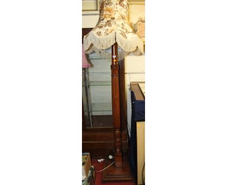 A mahogany reeded standard lamp, on square stepped base with shade