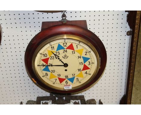 A reproduction circular stained wood wall clock, Bears RAF painted insignia, dia. 33cmMechanical movement.Appears to work but
