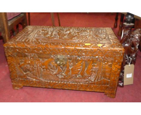 A small Eastern relief carved camphorwood hinge top low chest, width 55.5cm, together with a carved Chinese hardwood table la