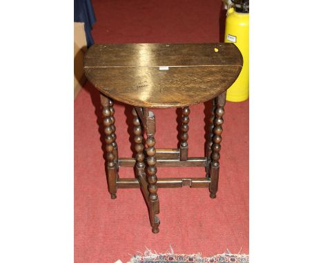 An early 20th century oak bobbin turned small gateleg occasional table 