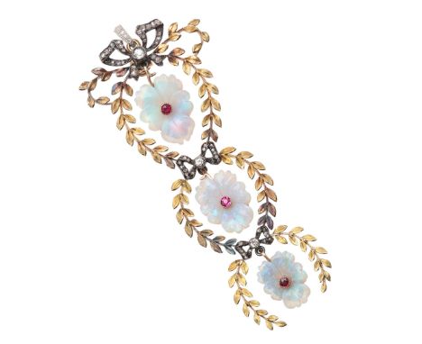 AN EARLY 20TH CENTURY OPAL, RUBY AND DIAMOND PENDANT. formed as three graduated gold wreaths each centred with a foliate carv