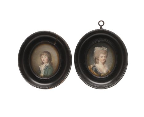 A PAIR OF MINIATURE PORTRAITS. of a lady , her hair dressed with roses and wearing grey silk dress  and the companion portrai