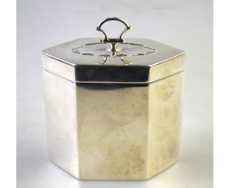 An Edwardian silver Adam revival tea caddy of elongated hexagonal form, the hinged cover embossed with oval fan patera centre