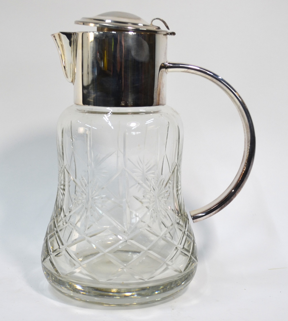 A heavy cut glass cocktail jug of waisted form, with electroplated ...