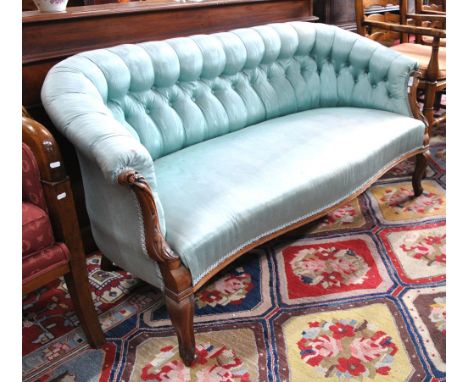 A Victorian carved walnut framed button back blue silk upholstered small salon sofa, 150 cm long