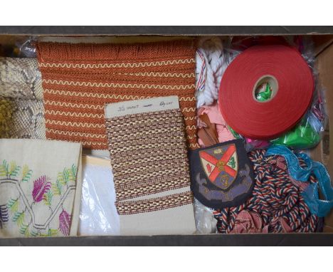 A box of assorted vintage braidings, ribbon, old school badges and other haberdashery, to/w a box of skeins of mohair wool, J