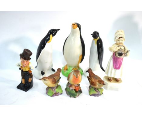 A small collection of ornaments comprising:  Two Poole Pottery penguins, Avon Ware penguin, Royal Worcester figure - 'Polly p
