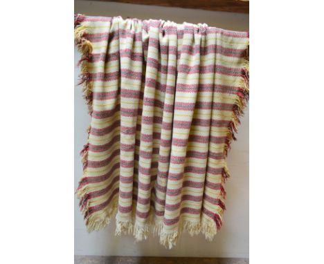 Three vintage Welsh wool blankets comprising; a cream ground example with red/green zig-zag and striped pattern and fringed e