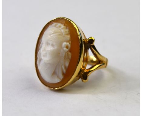 An oval 9ct shell cameo ring of female, yellow metal rubbed over setting with split shoulders, size K (sizeable)