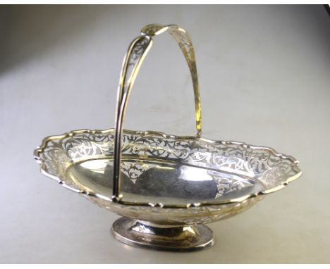 A Sheraton revival oval silver fruit basket with swing handle, pierced decoration and raised foot, R. F. Mosely & Co., Sheffi