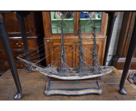 An antique solid-hull model of a three-masted sailing ship with extensive rigging and deck details, 50 x 75 cm
