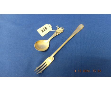 A continental silver caddy spoon and a hm silver pickle fork