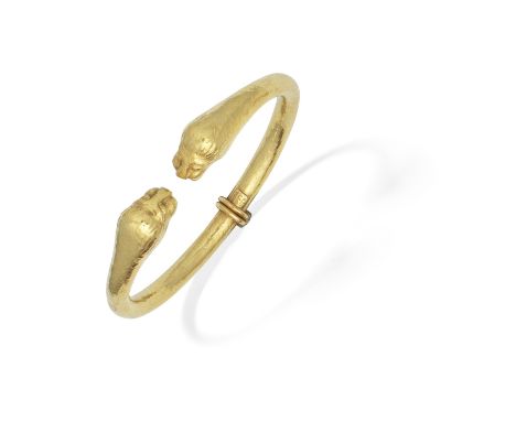 ZOLOTAS: LION HEAD BANGLEThe hinged bangle of hammered finish, each terminal depicting a lion's head, signed Zolotas,  inner 