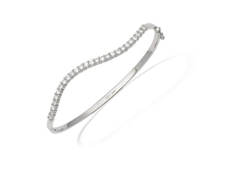 DIAMOND BANGLESet to the front with an undulating row of brilliant-cut diamonds,  diamonds approx. 1.30cts total, partial Lon
