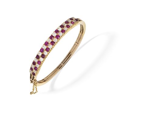RUBY AND DIAMOND CHEQUERBOARD BANGLE, CIRCA 1890Set with alternating cushion-shaped diamonds and circular-cut rubies, on a tr