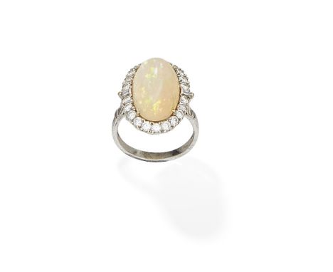 OPAL AND DIAMOND CLUSTER RING, 2011The oval opal cabochon set within a surround of brilliant and tapered baguette-cut diamond