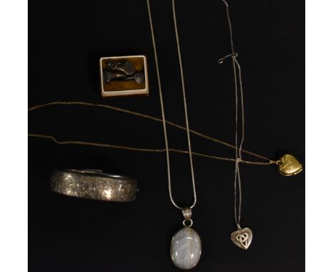 A hallmarked silver bangle; two silver pendants; a heart shaped locket; four silver rings