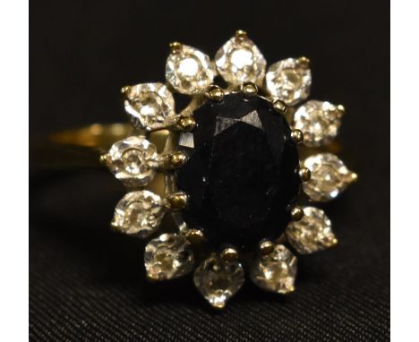 A 9ct gold blue and white sapphire oval cluster ring, London 1988, 3.3g gross