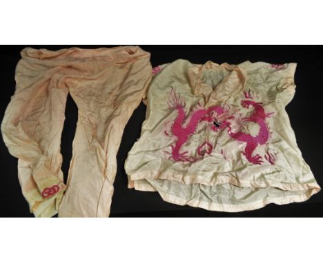 Textiles - a pair of vintage Chinese lady's pink pyjamas, embroidered in coloured silk threads with ferocious dragons, c. 193