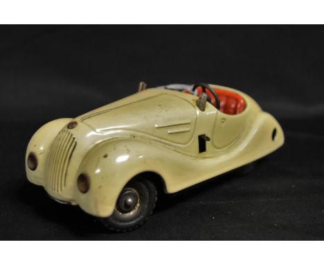 Schuco (Germany) a pre-war Examico 4001 clockwork tinplate car, cream body, red seats, tin-printing detail dashboard, missing