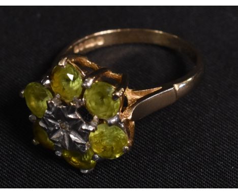 A 9ct gold green tourmaline and diamond accented cluster ring, London 1979, 3.9g gross