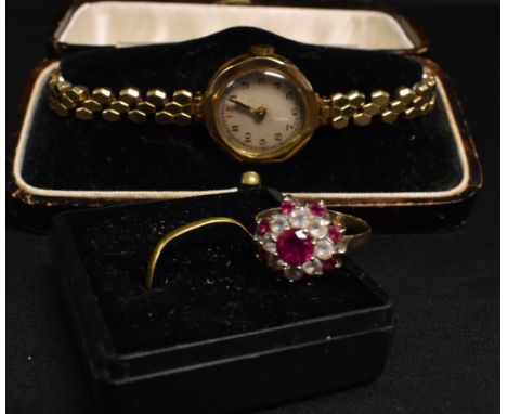 A lady's 9ct gold wristwatch, boxed; a 22ct gold wedding band, approx 0.9g; a 9ct gold cluster ring (3) 