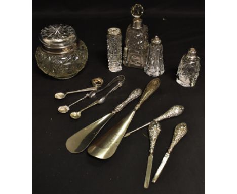 A silver hafted four piece manicure and shoe horn set; a silver top dressing table jar; a clear glass scent bottle with silve