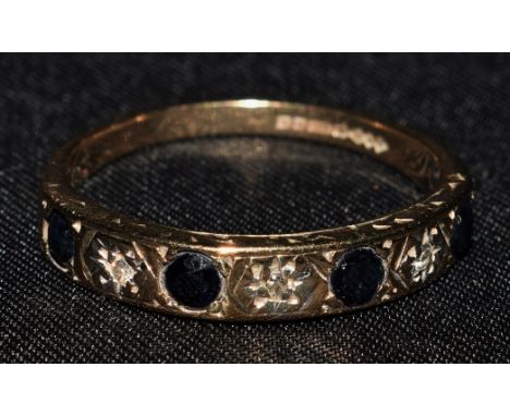 A 9ct gold dark blue spinel and diamond accented half eternity ring, Birmingham 1981, 1.7g gross