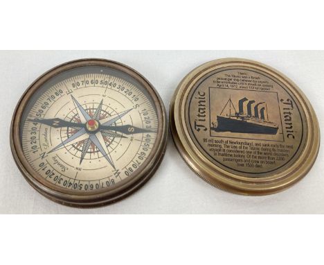 A brass cased compass with screw top lid featuring the Titanic. Picture and writing detail inside and out of lid. Approx. 7.7