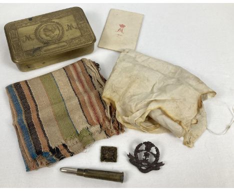 A WWI 1915 Princess Mary Christmas gift tin with original card. Tin also contains part of a silk parachute, a remnant of a st