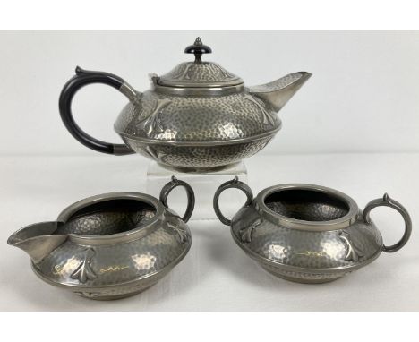 An antique Arts and Crafts pewter tea set by Civic, No. 3476. With hammered detail and trefoil style decoration. Bakelite han