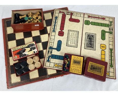 A vintage box of carved wooden chess pieces, with a Chad Valley chess board and boxed wooden draughts. Together with a boxed 