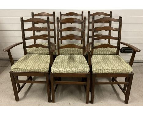 A set of 6 Ercol ladderback dining chairs, to include 2 carvers. All with matching green leaf seat pads. Blue &amp; gold squa