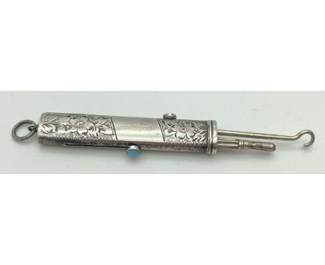 An antique silver propelling pencil and button hook. Floral engraving throughout with empty cartouche to front. Sliders to ea