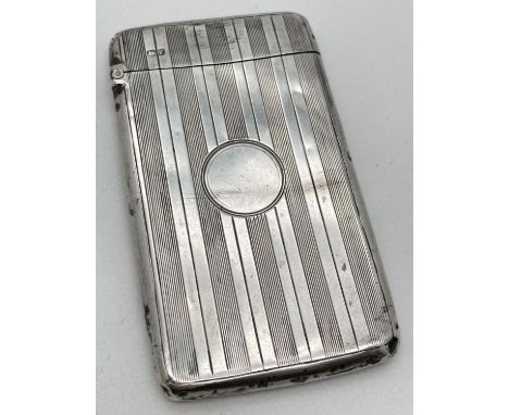 An Art Deco silver card case with engine turned design front and back. Features a blank circular cartouche to front, hallmark